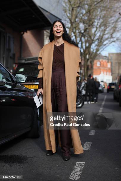 Caroline Issa is seen wearing a brown dress with a camel coat outside the Erdem show during London Fashion Week February 2023 on February 19, 2023 in...