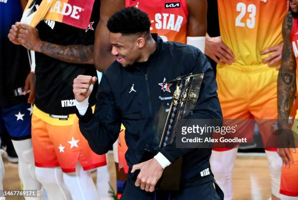 Giannis Antetokounmpo of the Milwaukee Bucks celebrates a win while holding the All Star Game trophy after the 2023 NBA All Star Game between Team...