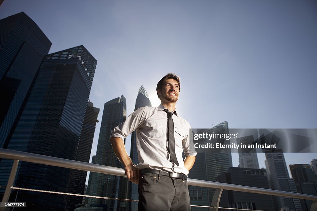 Modern businessman in city, smiling