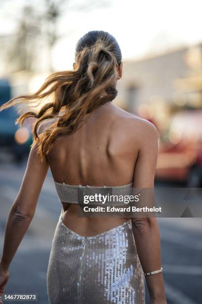 Tamara Kalinic wears a beige embroidered sequined halter-neck / shoulder-off / slit long dress a gold and diamonds Love bracelet from Cartier, a gold...