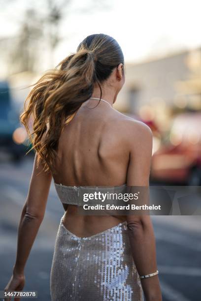 Tamara Kalinic wears a beige embroidered sequined halter-neck / shoulder-off / slit long dress a gold and diamonds Love bracelet from Cartier, a gold...