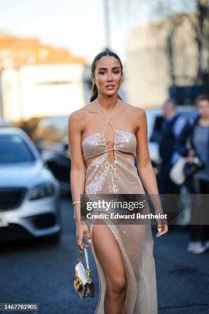 Tamara Kalinic wears a beige embroidered sequined halter-neck / shoulder-off / slit long dress a gold and diamonds Love bracelet from Cartier, a gold...