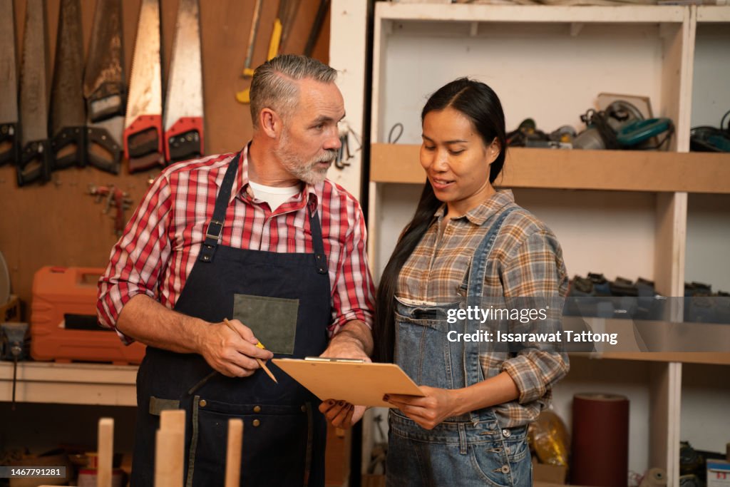 Craftsman Senior Man Teaching Woman Apprentice At Woodshop Carpenter ...