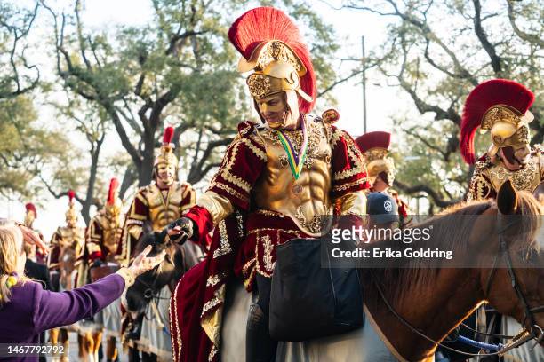 The Krewe of Bacchus lieutenants hand out doubloons during the 2023 Krewe of Bacchus parade on February 19, 2023 in New Orleans, Louisiana.