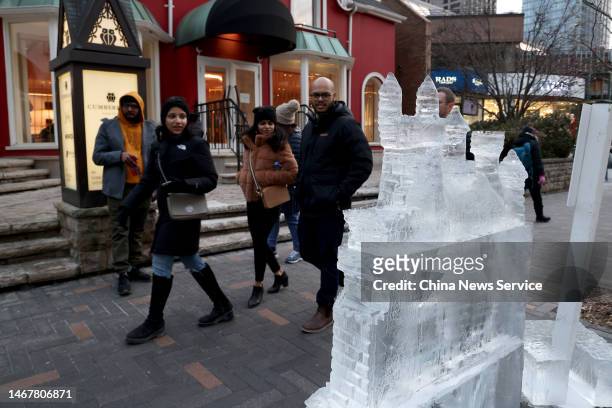 People view an castle-shaped ice sculpture during the 2023 Bloor-Yorkville Icefest on February 18, 2023 in Toronto, Canada.