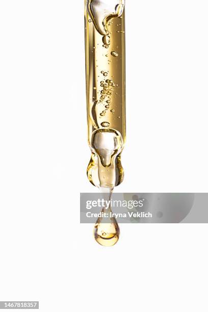 close-up pipette with face serum or essential oil with oxygen aqua bubbles and a drop of liquid on a pastel white gray color background. - pipette stock-fotos und bilder
