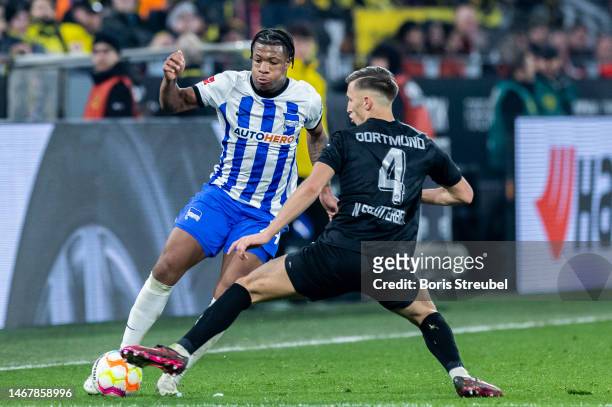 Jessic Ngankam of Hertha BSC is challenged by Nico Schlotterbeck of Borussia Dortmund during the Bundesliga match between Borussia Dortmund and...