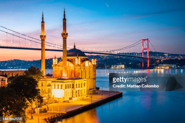 ortakoy mosque and bridge at dusk, istanbul, turkey - bosphorus bridge stock pictures, royalty-free photos & images