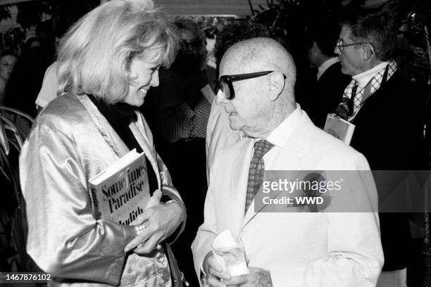 Angie Dickinson, Irving 'Swifty' Lazar, and Roddy McDowall attend a party in Beverly Hills, California, on June 25, 1987.