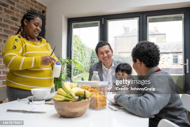 young family enjoying breakfast routine together - family wellbeing stock pictures, royalty-free photos & images