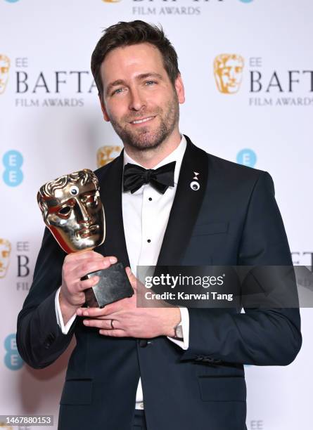 Paul Rogers poses with the Editing Award for 'Everything Everywhere All At Once' during the 2023 EE BAFTA Film Awards 2023 at The Royal Festival Hall...