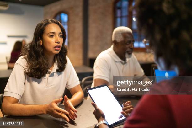 businesswoman doing a staff meeting in the office - employee welfare stockfoto's en -beelden