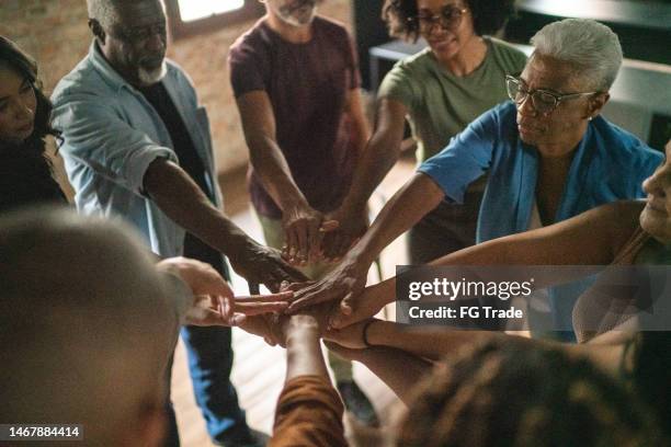 business team holding their hands together - sea of hands stock pictures, royalty-free photos & images