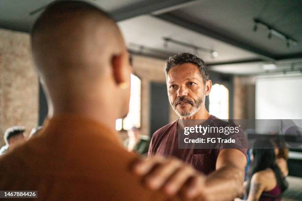 mature man giving support during a psychotherapy - receiving treatment concerned stock pictures, royalty-free photos & images