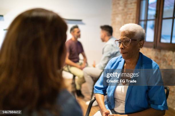 two women talking at counselling session - victim advocacy stock pictures, royalty-free photos & images