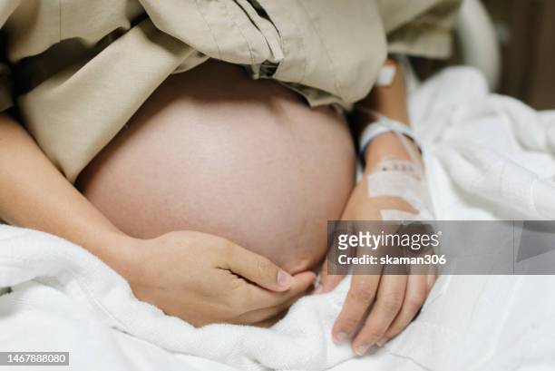 close up belly of asian mother pregnant 40 weeks ready to give birth - caesarean section stock pictures, royalty-free photos & images