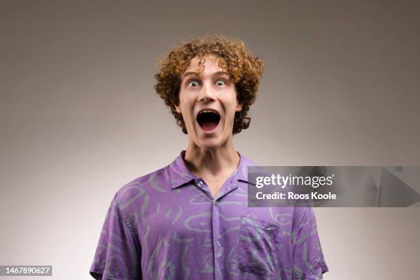 young man - grimassen stockfoto's en -beelden