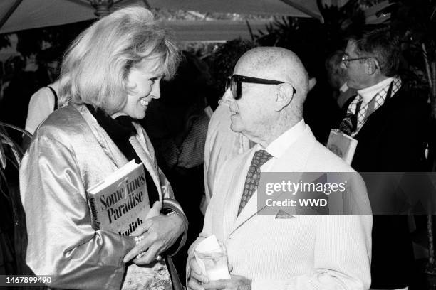 Angie Dickinson, Irving 'Swifty' Lazar, and Roddy McDowall attend a party in Beverly Hills, California, on June 25, 1987.