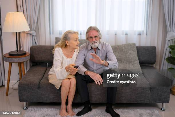 senior couple watch television at home. - alter tv stock pictures, royalty-free photos & images