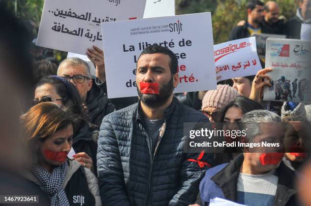 February 2023: Chairman of the Tunisian Journalists' Association Mohamed Yassine Jlassi put a sticky tape on his mouth to symbolise the restriction...