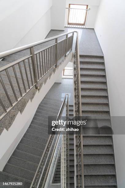 high angle view of stairs in a building - spiral staircase stockfoto's en -beelden