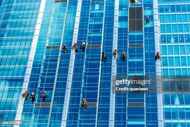 warsaw business district with window cleaners - window cleaning stock pictures, royalty-free photos & images