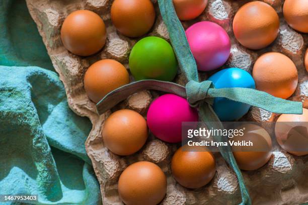 creative easter design concept with colorful painted easter eggs and turquoise color linen fabric tape and tablecloth on sunny background. viva magenta color of the 2023 year. - shopping easter bildbanksfoton och bilder