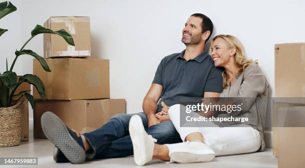 moving, boxes and couple relax on floor with room planning, happy with real estate and property investment. mature people or woman with partner thinking of finance success for apartment or house - dreaming of home ownership stock pictures, royalty-free photos & images