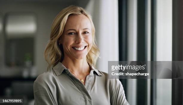 leadership, portrait and business woman in the office with positive, happy and optimistic mindset. happiness, smile and professional mature female executive boss standing with confidence in workplace - happy office workers stockfoto's en -beelden