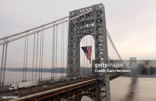 Vehicles cross the George Washington Bridge linking New Jersey to New York City as it displays its 60 by 90 foot American flag to mark President's...