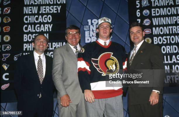 Number One overall pick Bryan Berard of the Ottawa Senators stands with NHL commissioner Gary Bettman on July 8, 1995 at the Edmonton Coliseum in...