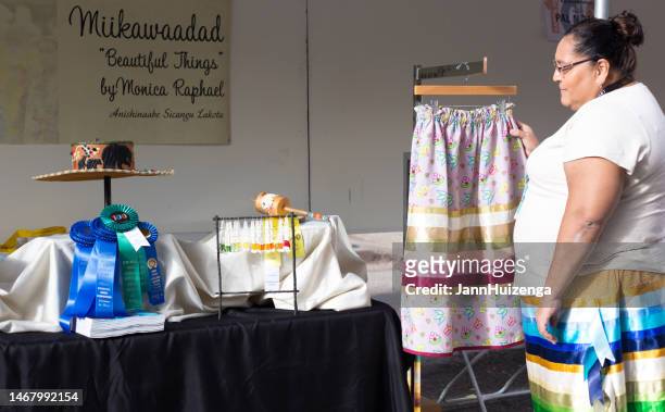 santa fe indian market 2022: native fashion designer in booth - multi colored skirt stockfoto's en -beelden