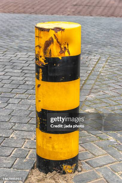 battered steel traffic bollard - bollards stock pictures, royalty-free photos & images