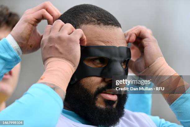 Kyle Sinckler of England wears a face mask during a training session at Pennyhill Park on February 20, 2023 in Bagshot, England.