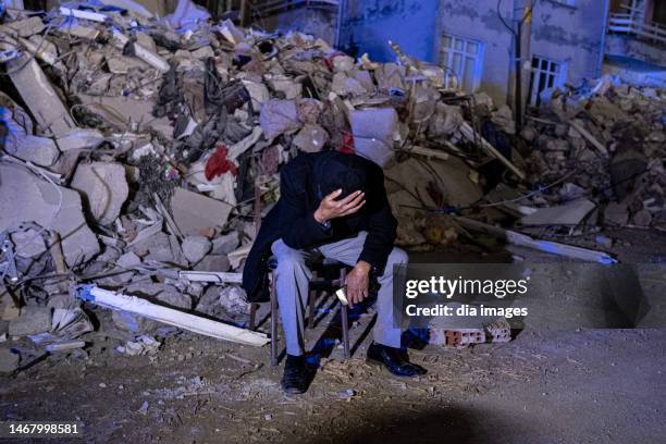 People waiting at the head of a building destroyed in the earthquake on February 20, 2023 in Hatay, Türkiye. Two more earthquakes of 6.4 and 5.8...