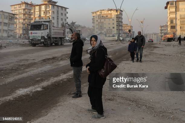 Woman waits for the body of a relative in front of rubble from destroyed buildings on February 20, 2023 in Hatay, Turkey. A 7.8-magnitude earthquake...