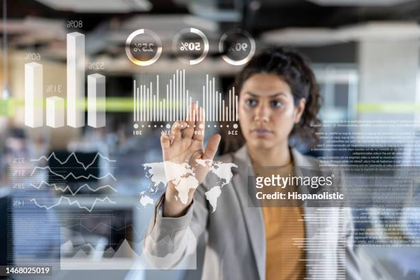 business woman looking at the market data on an interactive screen - hud graphic stock pictures, royalty-free photos & images