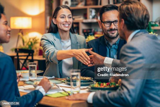 business handshake at the restaurant - corporate lunch stock pictures, royalty-free photos & images