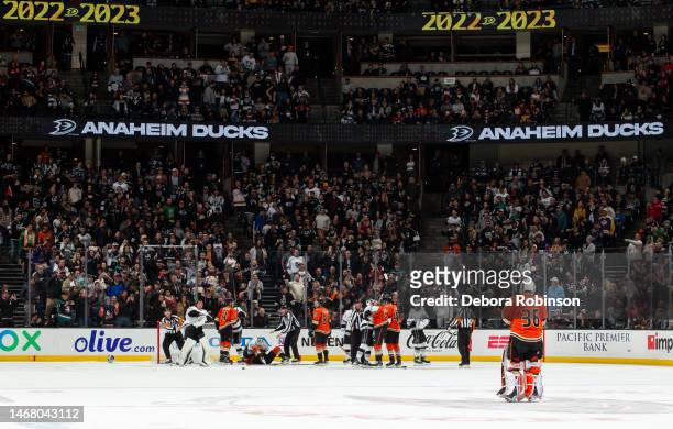 Goaltender John Gibson of the Anaheim Ducks looks on as officials separate a scrum at the opposite crease that resulted in a match penalty for...