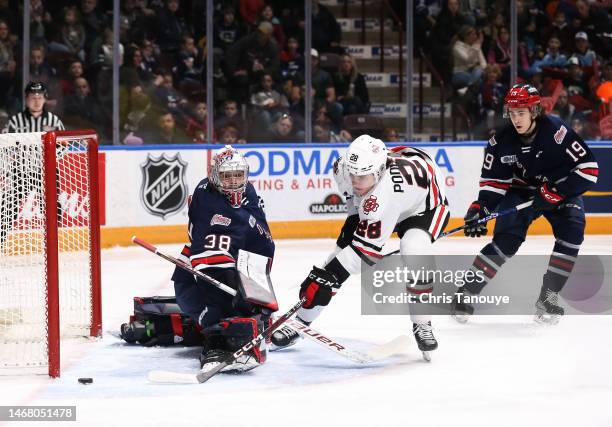 Michael Podolioukh of the Niagara IceDogs shot goes wide of Jacob Oster of the Oshawa Generals net during the first period at Tribute Communities...