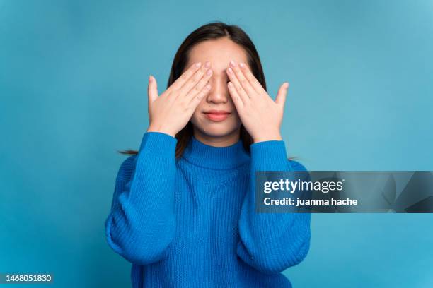 scared woman covering eyes with hands - guess who stock pictures, royalty-free photos & images