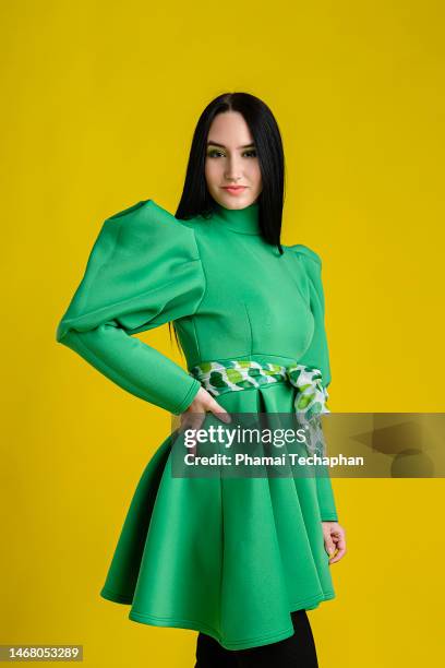 beautiful woman wearing green dress - hand on hip stock pictures, royalty-free photos & images