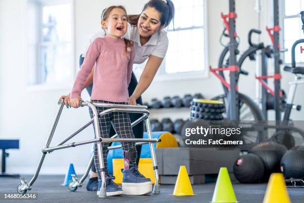 learning to use a walker - orthopedic equipment stock pictures, royalty-free photos & images