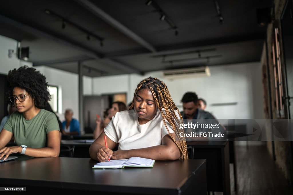Student taking notes during class