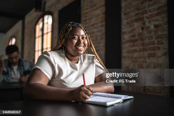 portrait of a young woman in the classroom - large auditorium stock pictures, royalty-free photos & images