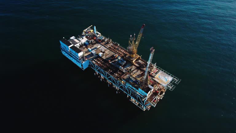 Cargo Rigs Close Off-Shore Oil and Gas Drilling Rig with Cargo Ships in Distance ...