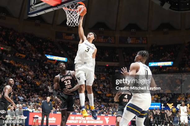 Tre Mitchell of the West Virginia Mountaineers dunks the ball in the second half during a college basketball game against the Oklahoma State Cowboys...