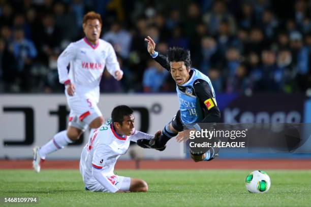 Kengo Nakamura of Kawasaki Frontale is tackled by Cho Byung-kuk of Jubilo Iwata during the J.League Yamazaki Nabisco Cup Group A match between...