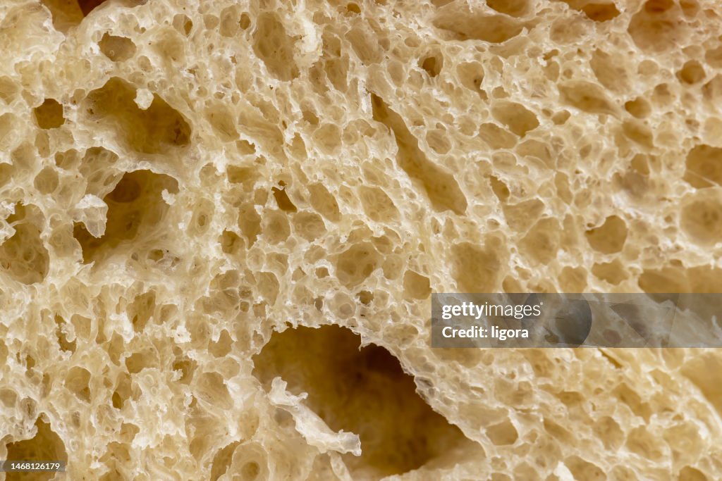 A cut loaf of round-shaped wheat bread