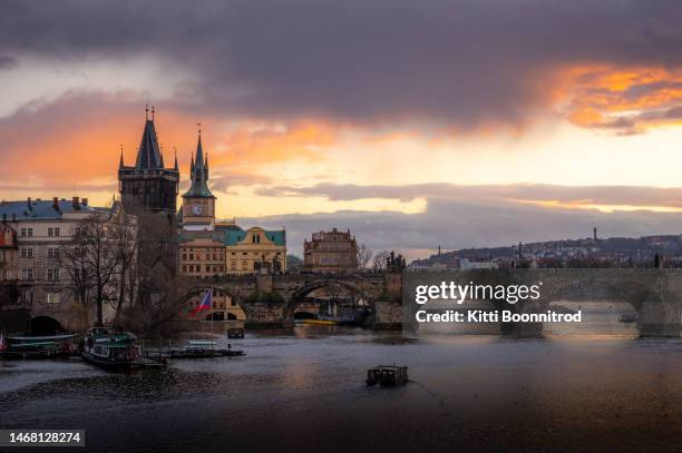 view of charles bridge during sunset - prague clock stock pictures, royalty-free photos & images
